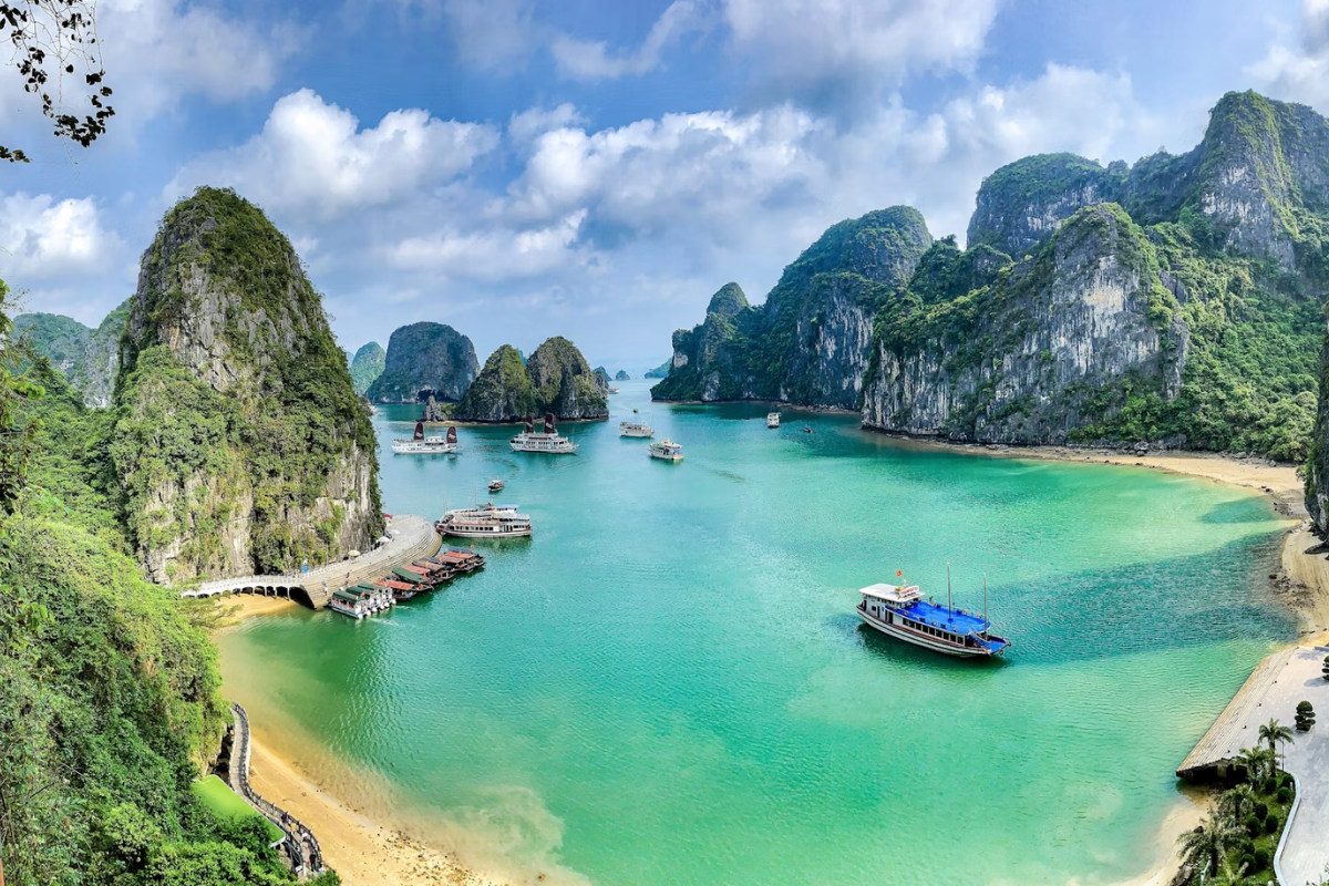 Sunrise over Halong Bay with misty limestone peaks
